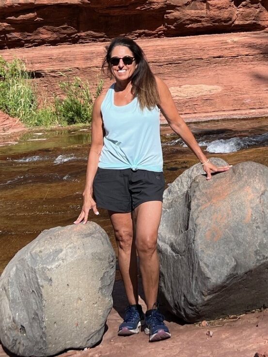 Maria Berry standing in front of red rocks